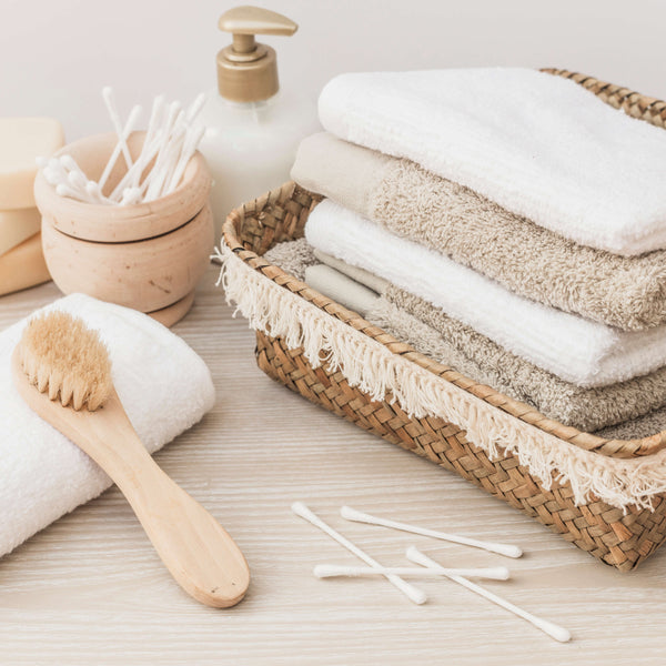 https://kcnmoon.com/cdn/shop/articles/stacked-towels-brush-soap-cotton-swab-cosmetic-bottle-wooden-background_600x600_crop_center.jpg?v=1652381969